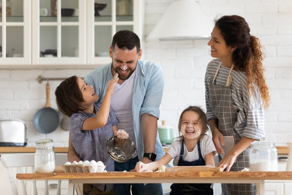 Parents and their children cooking together